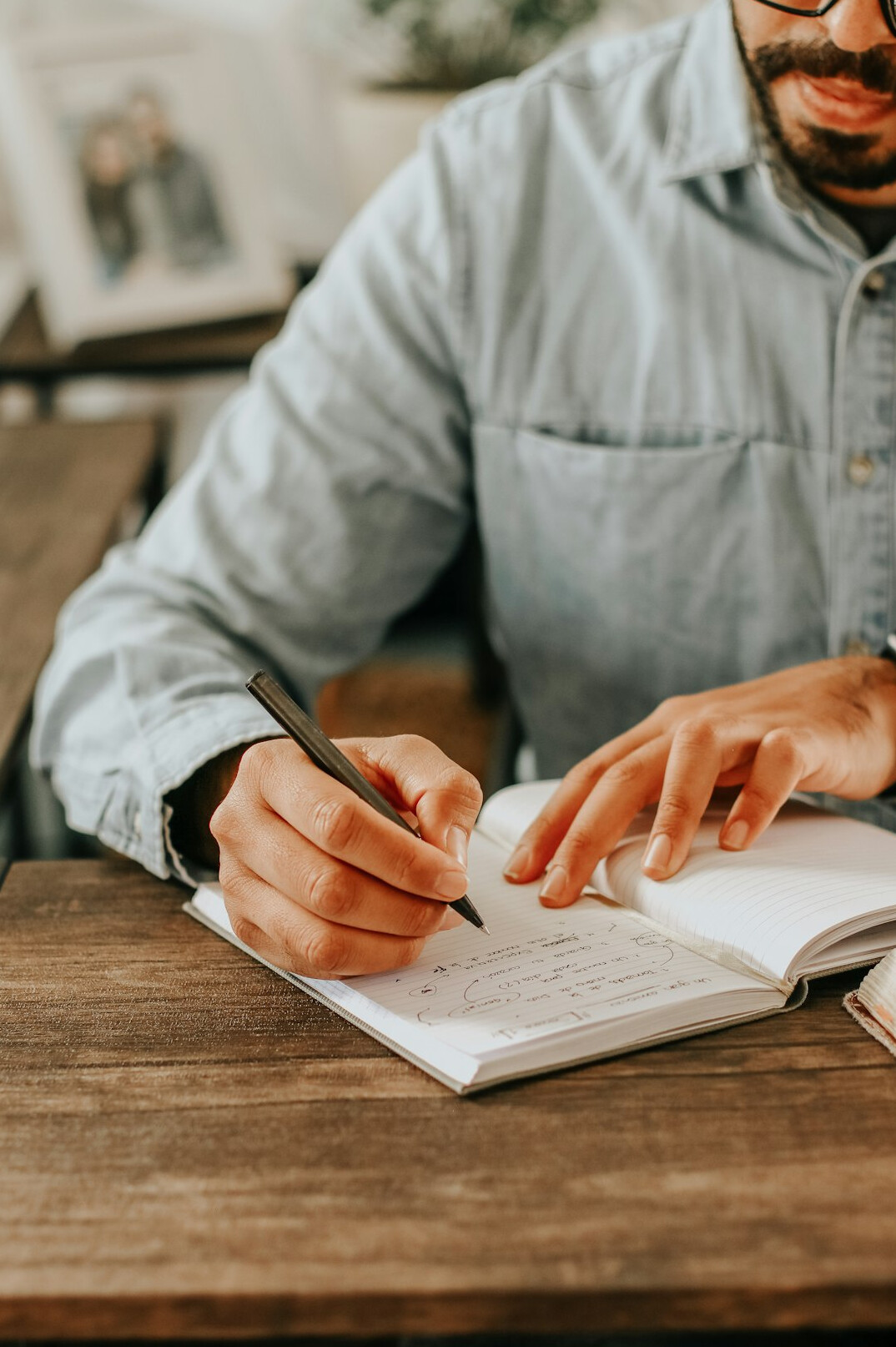 person writing goals in journal