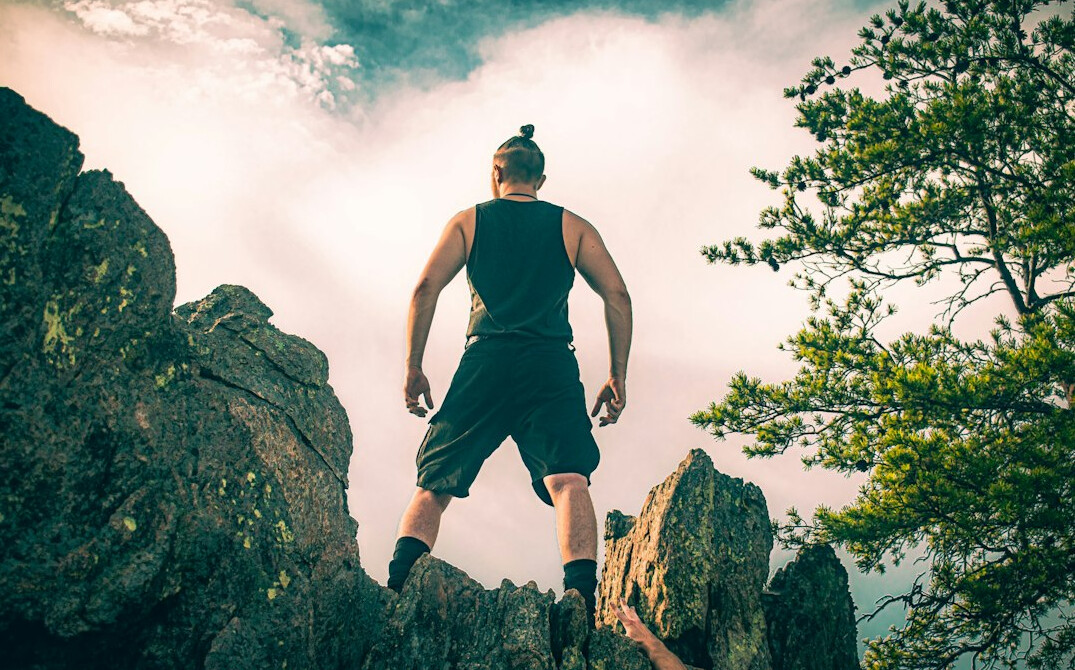 person achieving goals outdoors